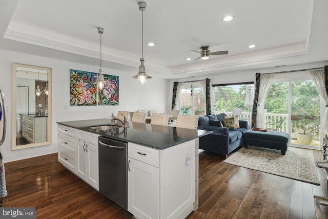 kitchen featuring sink, dishwasher, white cabinetry, a raised ceiling, and dark stone counters