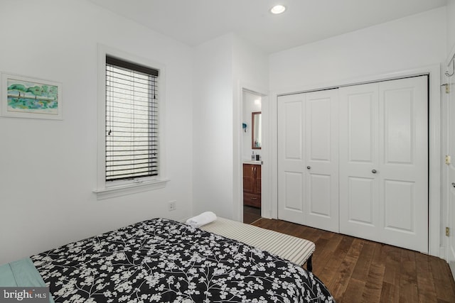 bedroom featuring dark hardwood / wood-style flooring and a closet