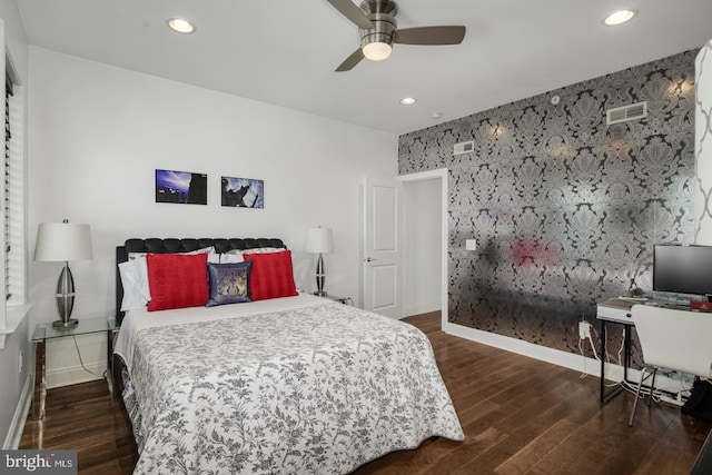 bedroom with dark hardwood / wood-style floors and ceiling fan