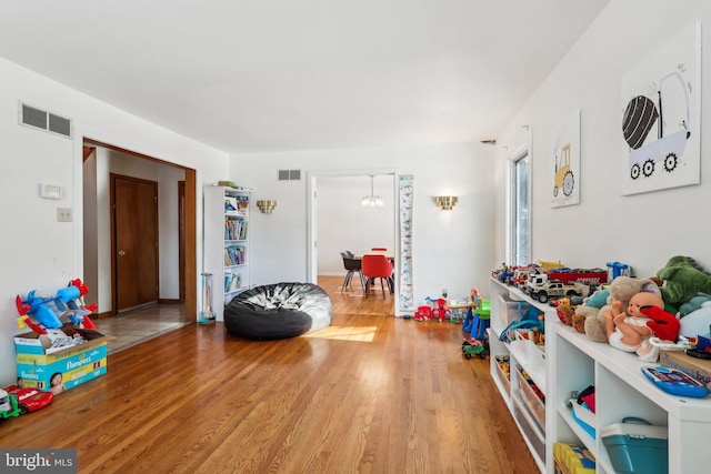 recreation room with hardwood / wood-style floors