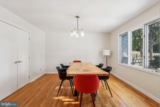 dining area featuring a notable chandelier and light hardwood / wood-style flooring