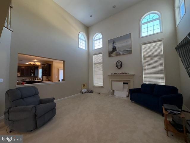 living room with carpet floors and a high ceiling