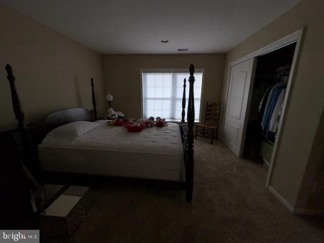 carpeted bedroom with a closet