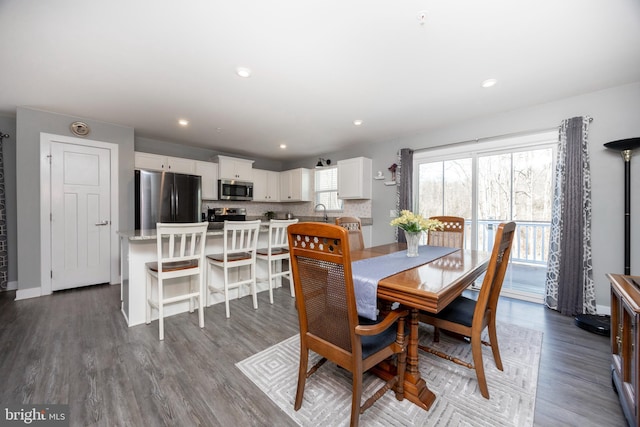 dining space featuring wood-type flooring