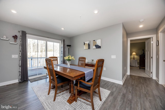 dining space with dark hardwood / wood-style floors and radiator