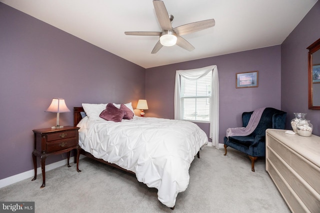 bedroom featuring light colored carpet and ceiling fan