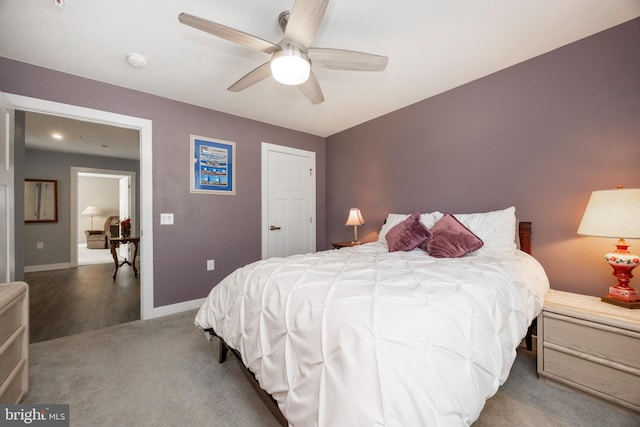 bedroom featuring dark carpet and ceiling fan