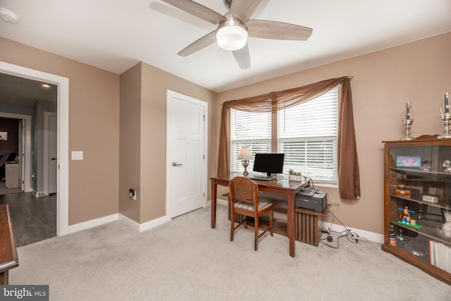 carpeted office space with ceiling fan