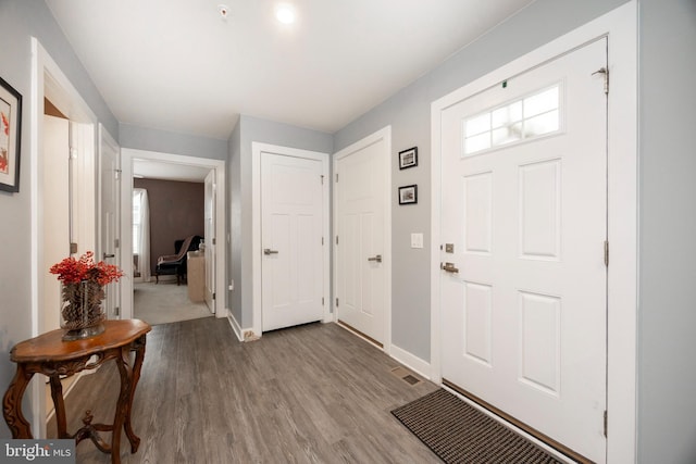 foyer entrance with light hardwood / wood-style floors