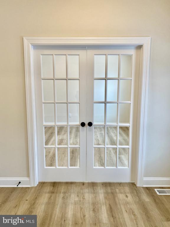 entryway featuring french doors and light hardwood / wood-style flooring