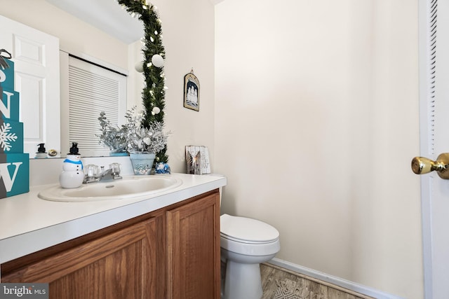 bathroom with vanity, hardwood / wood-style floors, and toilet