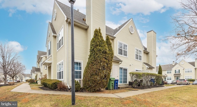 view of side of property with a yard