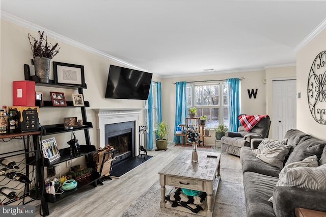 living room featuring ornamental molding and light wood-type flooring