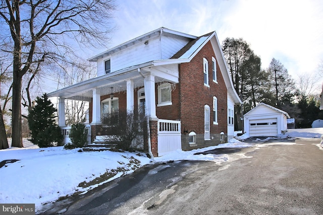 view of front of home with a garage, an outdoor structure, and covered porch