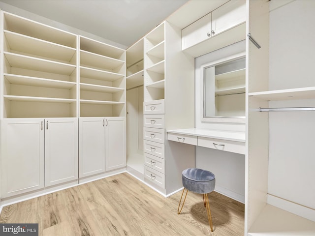 walk in closet with light wood-type flooring