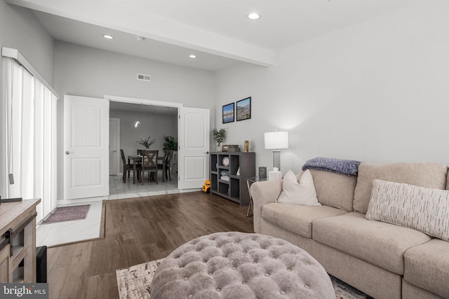 living room featuring hardwood / wood-style floors and beamed ceiling