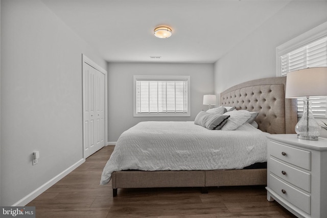 bedroom featuring dark hardwood / wood-style flooring and a closet