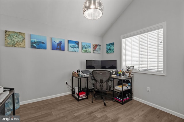 office with lofted ceiling and hardwood / wood-style floors