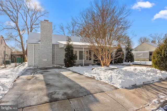 view of snow covered rear of property