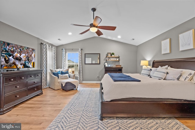 bedroom with vaulted ceiling, ceiling fan, and light wood-type flooring