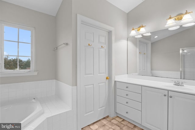 bathroom with vanity and tiled bath