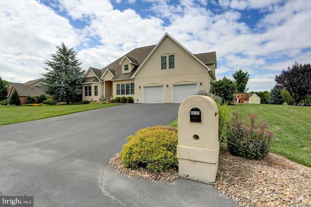 view of front of property with a garage and a front lawn