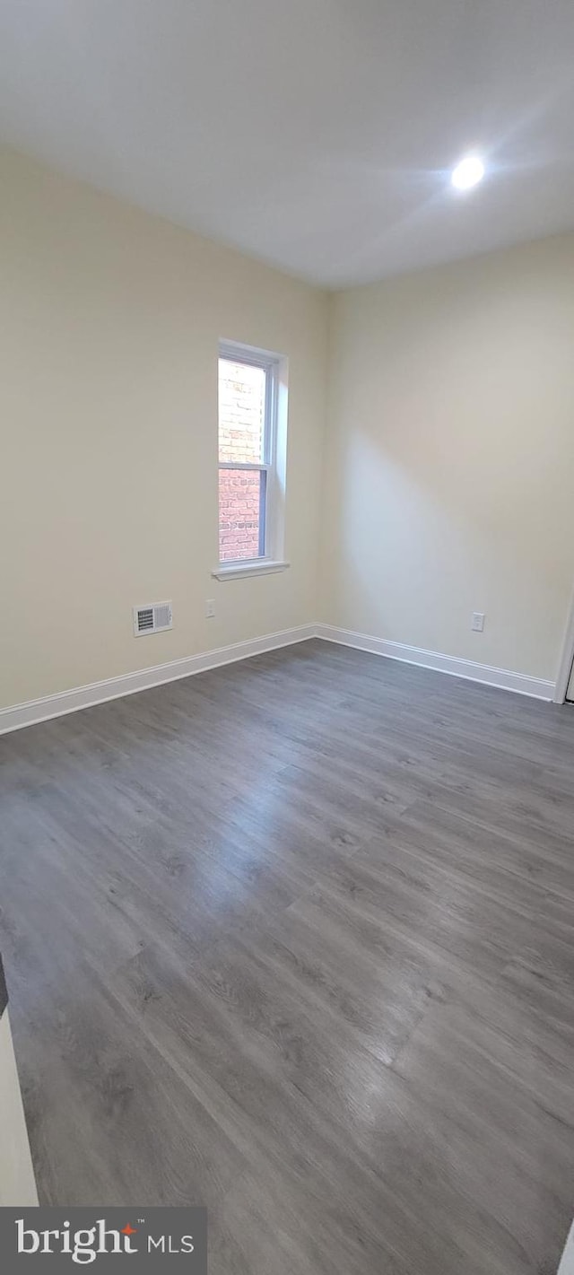 empty room featuring dark hardwood / wood-style flooring