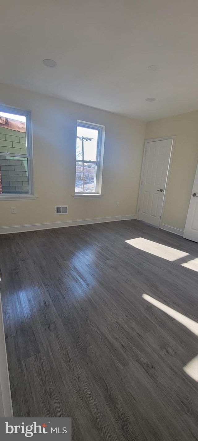 empty room with dark hardwood / wood-style floors