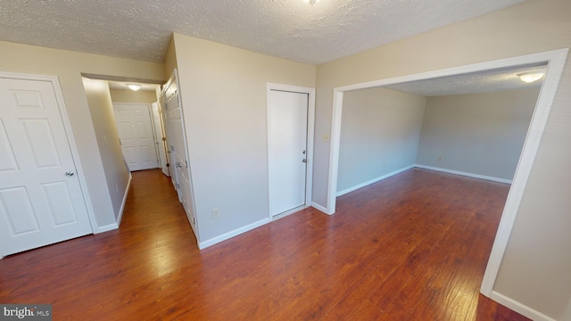 12459 Charter Oak Ct, Waldorf, MD 20601 - hallway featuring dark wood-type flooring and a textured ceiling