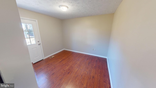 12459 Charter Oak Ct, Waldorf, MD 20601 - spare room featuring dark hardwood / wood-style floors and a textured ceiling