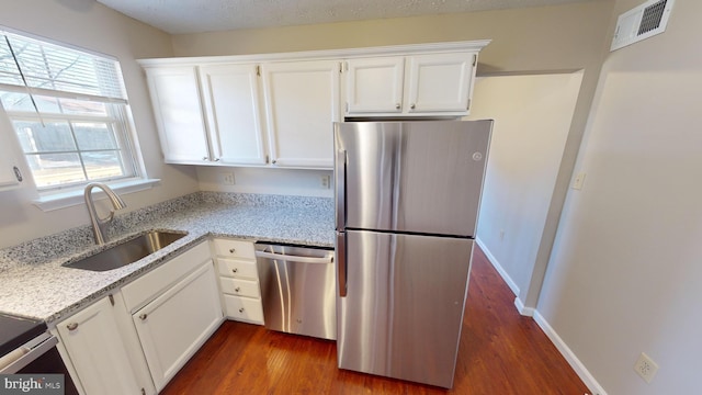 12459 Charter Oak Ct, Waldorf, MD 20601 - kitchen with sink, appliances with stainless steel finishes, dark hardwood / wood-style floors, light stone countertops, and white cabinets
