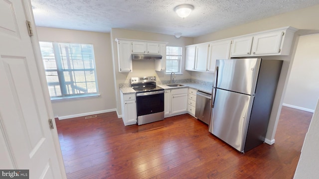 12459 Charter Oak Ct, Waldorf, MD 20601 - kitchen featuring white cabinetry, sink, stainless steel appliances, dark wood-type flooring, and a textured ceiling