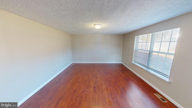 12459 Charter Oak Ct, Waldorf, MD 20601 - spare room featuring dark hardwood / wood-style floors and a textured ceiling