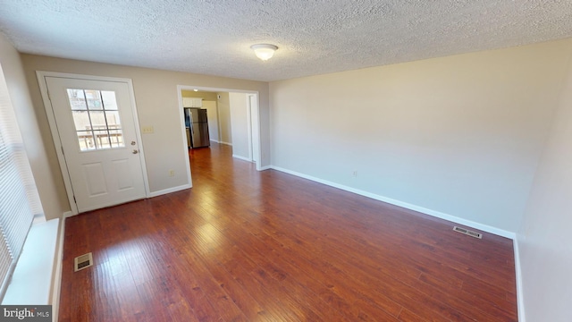 12459 Charter Oak Ct, Waldorf, MD 20601 - spare room featuring dark wood-type flooring and a textured ceiling