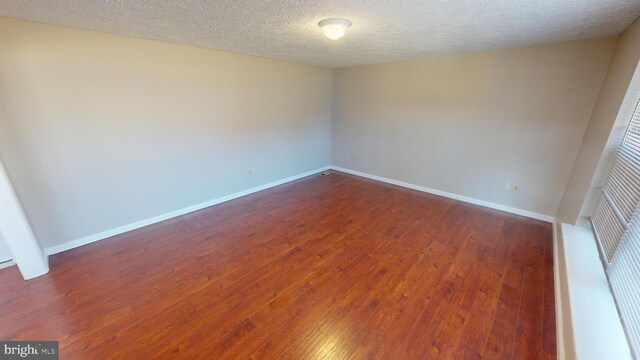 12459 Charter Oak Ct, Waldorf, MD 20601 - unfurnished room with dark hardwood / wood-style floors and a textured ceiling