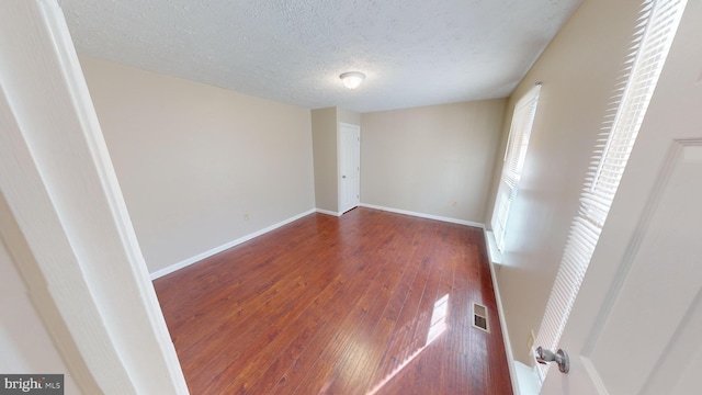 12459 Charter Oak Ct, Waldorf, MD 20601 - unfurnished bedroom with a textured ceiling and dark hardwood / wood-style flooring