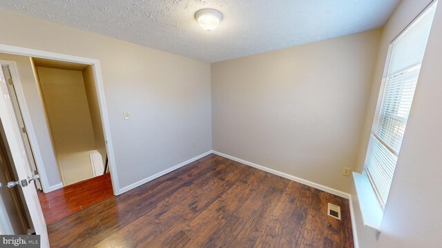 12459 Charter Oak Ct, Waldorf, MD 20601 - spare room featuring a textured ceiling and dark hardwood / wood-style flooring