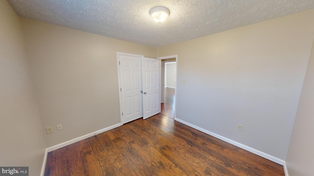 12459 Charter Oak Ct, Waldorf, MD 20601 - empty room with dark wood-type flooring and a textured ceiling