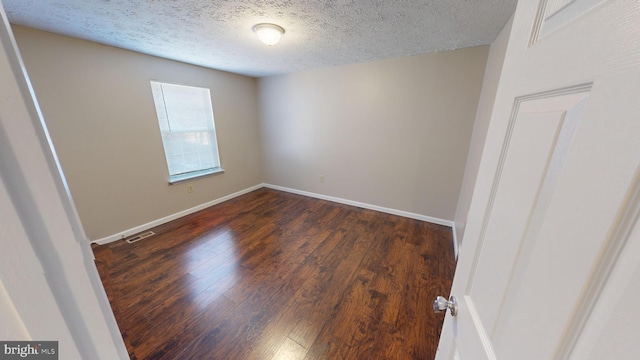 12459 Charter Oak Ct, Waldorf, MD 20601 - empty room with dark hardwood / wood-style flooring and a textured ceiling
