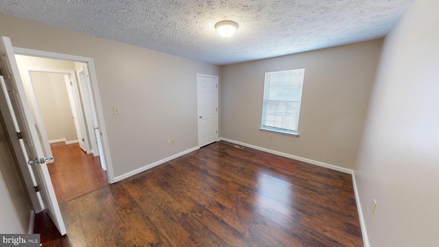 12459 Charter Oak Ct, Waldorf, MD 20601 - unfurnished bedroom with dark hardwood / wood-style floors and a textured ceiling