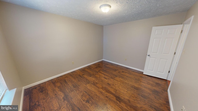 12459 Charter Oak Ct, Waldorf, MD 20601 - unfurnished room featuring dark hardwood / wood-style flooring and a textured ceiling