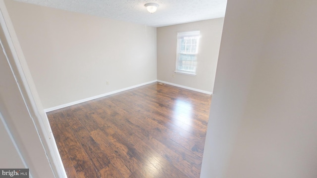 12459 Charter Oak Ct, Waldorf, MD 20601 - spare room featuring dark hardwood / wood-style flooring and a textured ceiling