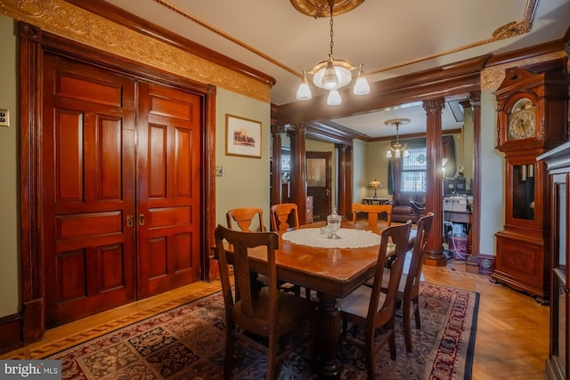 dining room with decorative columns and ornamental molding