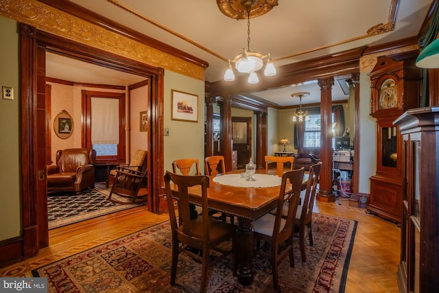 dining room with parquet flooring, ornamental molding, and decorative columns