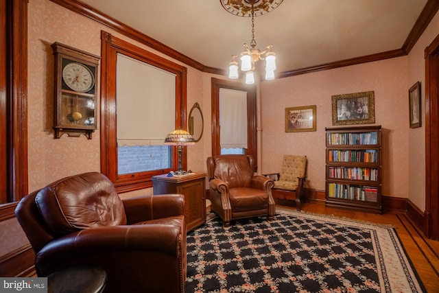 sitting room featuring an inviting chandelier, ornamental molding, and hardwood / wood-style flooring