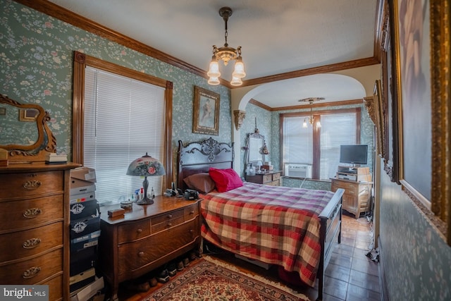 bedroom featuring an inviting chandelier and crown molding