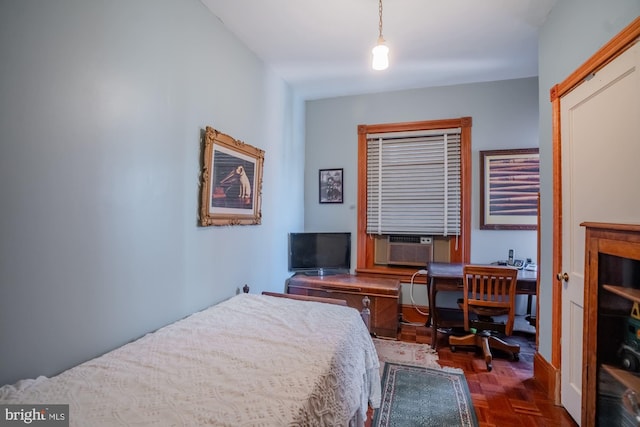 bedroom featuring cooling unit and dark parquet floors