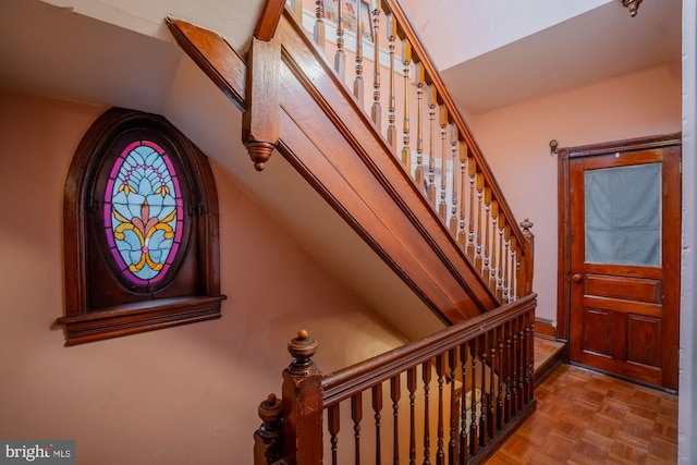 entryway with parquet flooring and vaulted ceiling