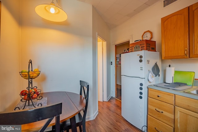 kitchen featuring light hardwood / wood-style flooring and white refrigerator