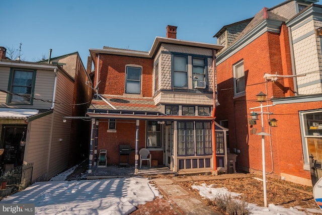 rear view of property with cooling unit and covered porch